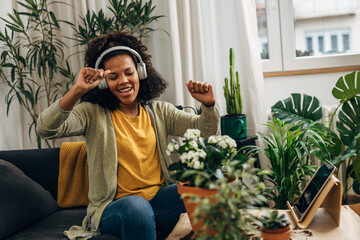 Cheerful woman sings while planting her houseplants