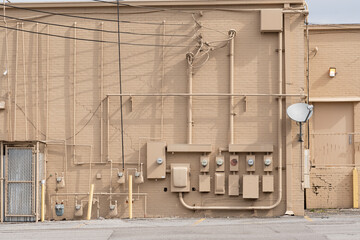 Back of Dilapidated Old Shopping Center With Electric Meters