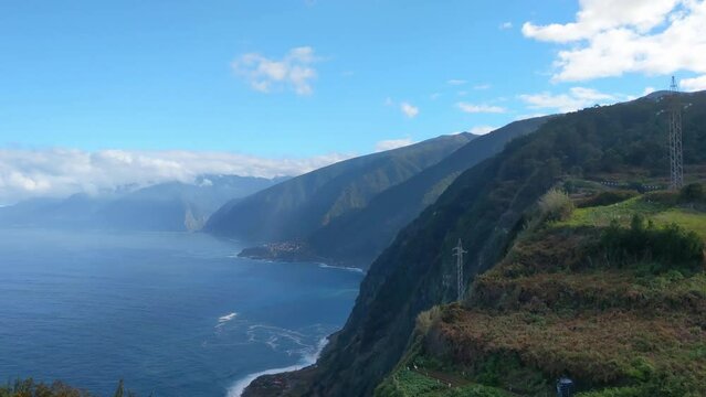 The green slopes of the island and the waves of the ocean. The coast of the island