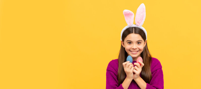happy easter teen girl in funny bunny ears hold painted eggs. Easter child horizontal poster. Web banner header of bunny kid, copy space.