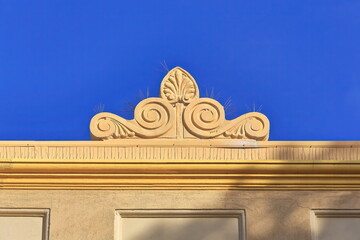 Baroque roof finial atop orange-yellow painted Art-Deco building on The Corso-Manly suburb. Sydney-Australia-530 © rweisswald