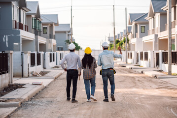 Multi ethnic people civil engineer and architech holding blueprint to audit in construction site,...