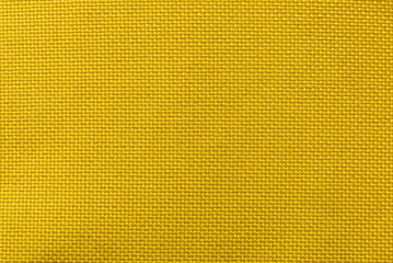 Yellow fabric texture. Textile. Canvas. Pattern on fabric with intersecting lines
