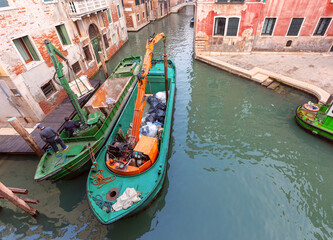 Fototapeta na wymiar Large barge for collecting garbage in a Venetian canal.