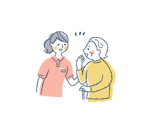 笑顔で話すシニア女性と介護スタッフ