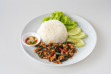 Fried rice with basil in a beautiful plate on white background