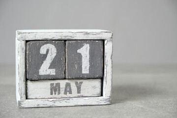 May 21 calendar made wooden cubes gray background.With an empty space for your text.