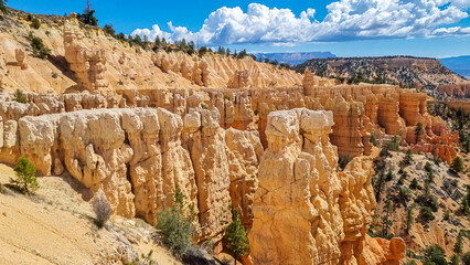 Scenic aerial view of Boat Mesa and massive hoodoo wall sandstone rock formation on Fairyland hiking trail in Bryce Canyon National Park, Utah, USA. Unique nature in barren landscape. Clouds emerging