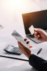 Close up of woman hand using credit card and laptop for payment and online shopping, Online shopping, payments digital banking, E-commerce concept.