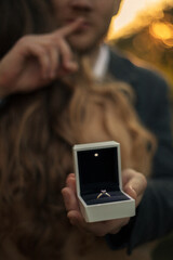 Ring in a box. An offer of me hand and heart. love story at sunset