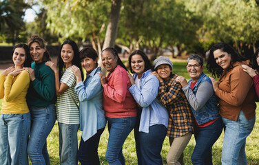 Fototapeta premium Group of diverse multi generational women smiling on camera at city park