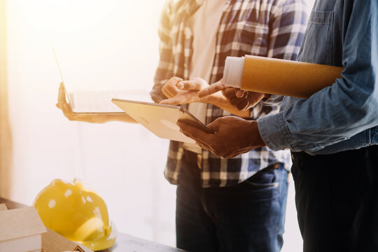 Construction and structure concept of Engineer or architect meeting for project working with partner and engineering tools on model building and blueprint in working site, contract for both companies.