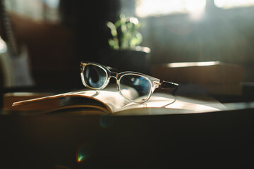 A close up shot of reading glasses on book