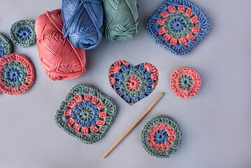 Layout of crochet things, including hand made motifs, a hook, sk