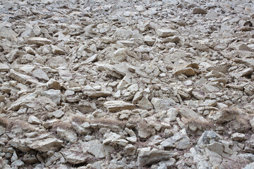 Plowed field with grey sandy soil ready to be sown