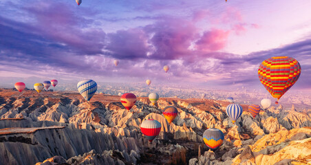 Amazing landscape view sunrise in Cappadocia with colorful hot air balloon deep canyons, valleys. Concept banner travel Turkey aerial top view - obrazy, fototapety, plakaty