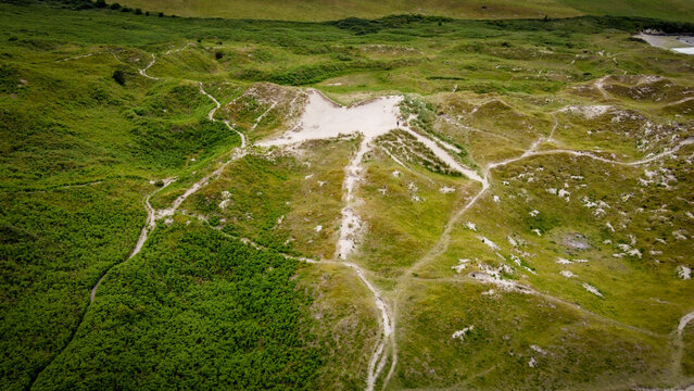 Picturesque sand hills of Ireland, top view. Sand dunes covered with vegetation.