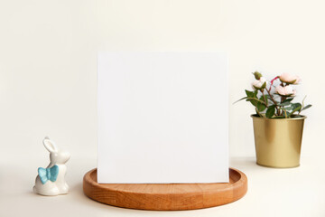 Blank Greeting Card, Invitation Mockup. Front view Easter Composition with Ceramic Bunny on Table. Copy space. Paper Spring Mock up Minimal Business Brand Template. Soft Shadow. Nordic Flier Design Ad