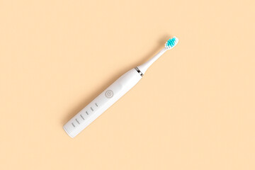 White Toothbrush on beige neutral pastel color studio background. Top View Flat Lay, Copy Space....