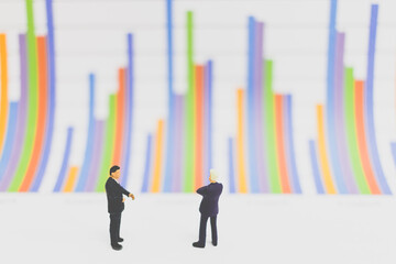 Miniature people businessman standing on chart