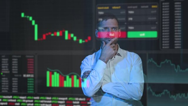 Caucasian bearded man analyzes stock charts on a virtual screen. HUD menu.