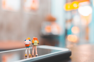 Miniature backpacker , Tourist people standing on smartphone , Travel concept