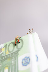 Miniature people , climber climbs on a EURO banknote