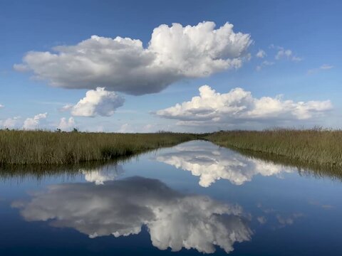 Gliding through the Florida Everglades with the sky reflecting in the wetlands