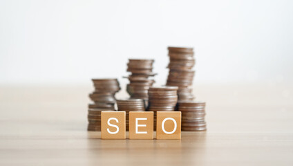 Text SEO on wood cube decorate with gold coins, marketing concept..