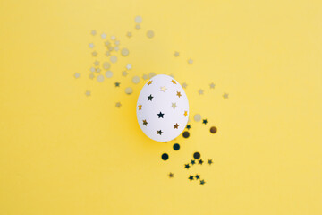 Easter eggs in decorated with a festive golden stars . Flat lay. Copy space for text