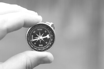 Old classic navigation compass in hand