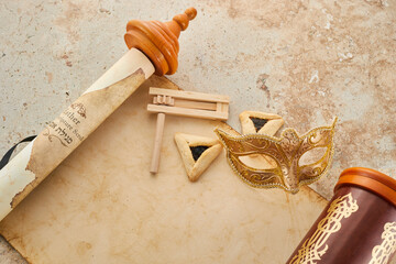 Scroll of Esther, haman's ears cookies and Purim Festival objects.
