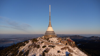 A bird's eye view of snow-covered Jested at sunrise. Photographed on the Jested ridge by drone....