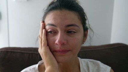 Sad woman taking a deep breath feeling anxious. Crying female person close up face with desperate expression and rubbing eye with hand during hard times