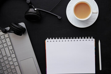 Traditional office lifestyle - mock up notebook with pen, laptop, cup of coffee and headphones. Freelance concept, working remotely, taking webinar, listening music, studying flat lay