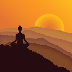 Silhouette of a woman meditating in the mountains at beautiful sunrise