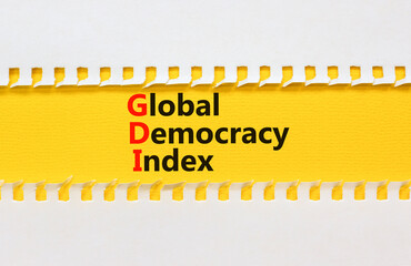 GDI global democracy index symbol. Concept words GDI global democracy index on yellow paper on a...