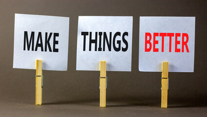Make things better symbol. Concept words Make things better on white paper on wooden clothespin on a beautiful grey table grey background. Business and make things better concept. Copy space.