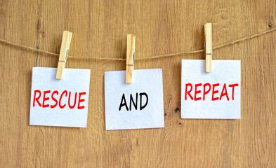 Rescue and repeat symbol. Concept words Rescue and repeat on white paper on wooden clothespin on a...