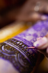Applying Beautiful henna art on hands. Bridal design. Wedding Mehendi. Indian arabian culture of...