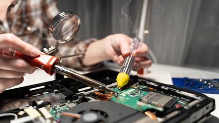 computer repairman soldering chip soldering iron