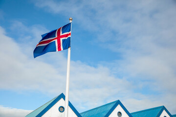 Flag of Iceland waving on the wind with blue sky background