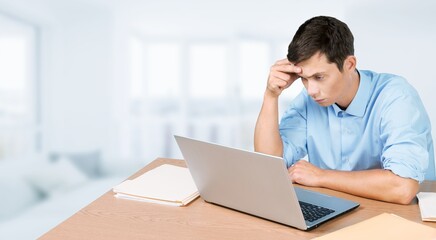 Bored young man using computer