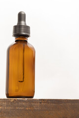 A dropper bottle in front of a white background