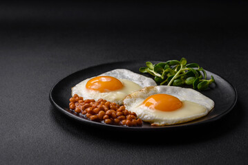 Delicious hearty breakfast consisting of two fried eggs, canned lentils and microgreens