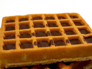 Chocolate waffles isolated on white background. Waffles in chocolate. Close-up.
