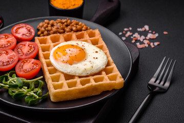 Delicious hearty breakfast consisting of a fried egg, Belgian waffle