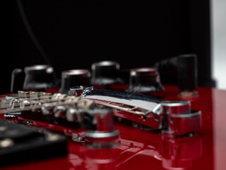 Fototapeta na wymiar Red electric guitar. Electric guitar settings. Red guitar. Close-up.
