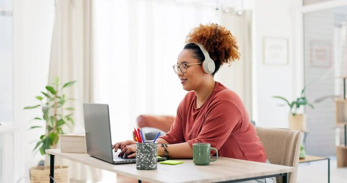 Laptop, typing and black woman with headphones in home office for project while streaming music. Freelancer, remote worker and happy female working on computer while listening to radio or podcast.