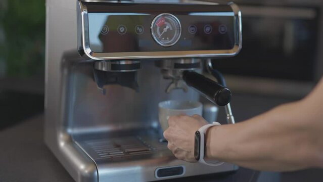 Caucasian female has just prepared espresso.